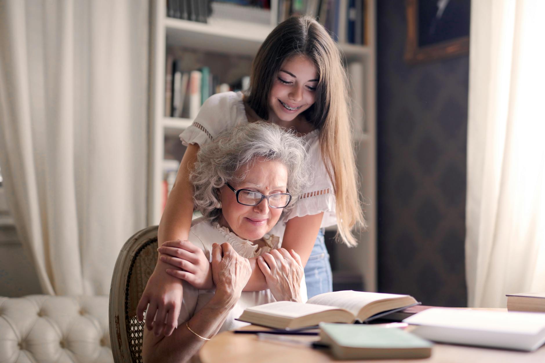 photo of woman embracing her grandmother